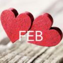 Pair of Hearts on weathered wood table with Feb month
